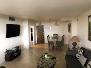 a living room with a couch and a table at Galt Ocean Drive Beach Condo in Fort Lauderdale