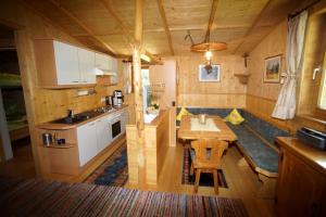 a kitchen with a table in a tiny house at Ferienhaus Stupp in Gries im Sellrain