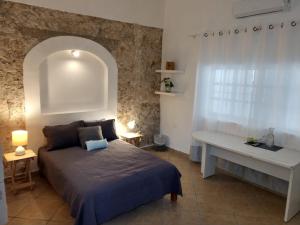 a bedroom with a bed and a white desk at Carlota Guest House in Cozumel