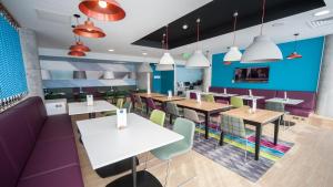 a dining room with tables and chairs at Holiday Inn Express Aberdeen Airport by IHG in Dyce
