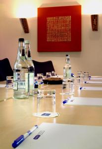 a table with bottles of water and glasses on it at Holiday Inn Express Aberdeen Airport by IHG in Dyce
