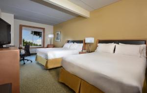 a hotel room with two beds and a flat screen tv at Holiday Inn Express Hotel & Suites High Point South, an IHG Hotel in Archdale