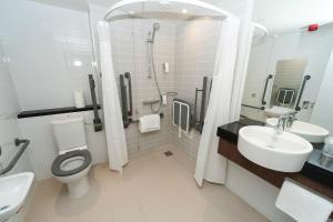 a bathroom with a toilet and a sink and a shower at Holiday Inn Express Aberdeen Airport by IHG in Dyce
