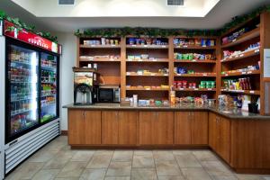 a grocery store with a counter and a refrigerator at Candlewood Suites New Iberia by IHG in New Iberia