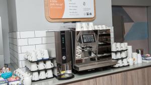 a coffee machine on a counter in a store at Holiday Inn Express Aberdeen Airport by IHG in Dyce
