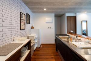 uma cozinha com um lavatório e um frigorífico em Ginowan - House / Vacation STAY 53141 em Ginowan