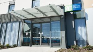 an entrance to a building with glass doors at Holiday Inn Express Aberdeen Airport by IHG in Dyce