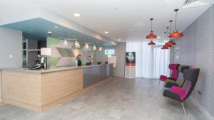 a lobby with a counter and chairs in a hospital at Holiday Inn Express Aberdeen Airport by IHG in Dyce