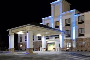un gran edificio blanco con luces azules. en Holiday Inn Express Adrian, an IHG Hotel, en Adrian