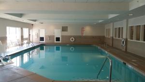 a large swimming pool with blue water in a building at Holiday Inn Express Augusta North, an IHG Hotel in Augusta