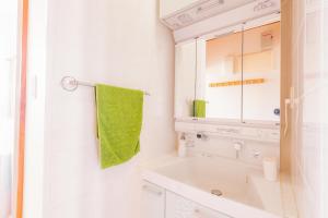 La salle de bains blanche est pourvue d'un lavabo et d'un miroir. dans l'établissement Kunigami-gun - House / Vacation STAY 53148, à Onna