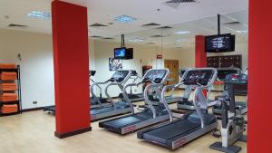 a gym with treadmills and elliptical machines at Copthorne Downtown by Millennium in Abu Dhabi
