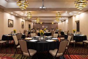 a conference room with tables and chairs and flowers at The Holiday Inn Amarillo West Medical Center, an IHG Hotel in Amarillo