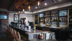 a bar with a counter and a lot of alcohol at Holiday Inn Hotel Atlanta-Northlake, a Full Service Hotel in Atlanta