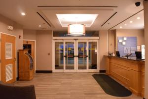 a lobby with a hair salon with a cash register at Holiday Inn Express Hotel & Suites Watertown - Thousand Islands by IHG in Watertown