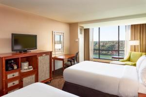 a hotel room with a bed, tv and a desk at Holiday Inn Austin -Town Lake, an IHG Hotel in Austin