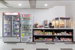two refrigerators in a store with food and drinks at Candlewood Suites - Celaya, an IHG Hotel in Celaya