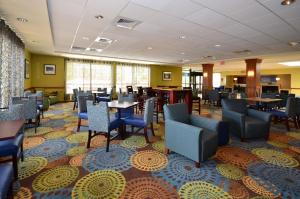 um restaurante com mesas e cadeiras num quarto em Holiday Inn Express Boston Brockton, an IHG Hotel em Brockton