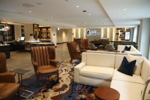 a lobby with a couch and chairs in a store at Hotel Indigo Naperville Riverwalk, an IHG Hotel in Naperville