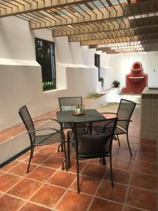 a patio with a table and chairs in a room at Meson de Maria in Antigua Guatemala