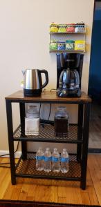 a shelf with bottles of water and a coffee pot at My Cozy Heavon in Chicago