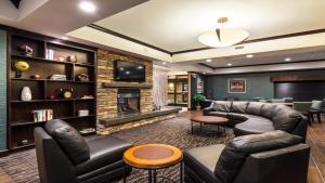 a living room with leather furniture and a fireplace at Holiday Inn Express Hotel & Suites Butte, an IHG Hotel in Butte