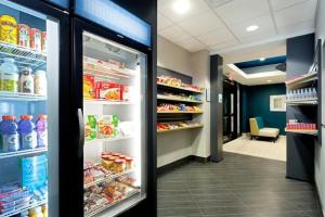 an open refrigerator in a store with food at Holiday Inn Express and Suites Batavia, an IHG Hotel in Batavia