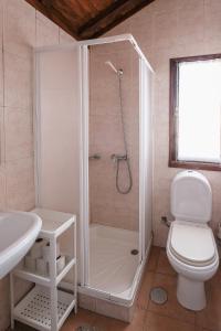 a bathroom with a shower with a toilet and a sink at Home of pilgrims d`Apúlia in Apúlia
