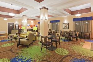 a lobby with tables and chairs in a room at Holiday Inn Express Columbia, an IHG Hotel in Columbia