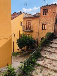 an old building with a staircase in front of it at Classic Home in Castelbuono