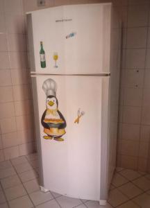 a refrigerator with a picture of a chef on it at Aconchegante e próximo à natureza! in Curitiba