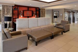 a living room filled with furniture and a tv at Holiday Inn Express Crestwood, an IHG Hotel in Crestwood