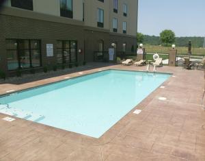 a large swimming pool in front of a building at Holiday Inn Express & Suites - Cleveland Northwest, an IHG Hotel in Cleveland