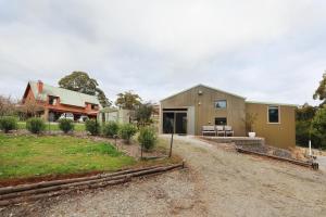 a house with a gravel driveway in front of it at Powerhouse @ Eagles Rise in Gawler