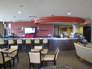 a restaurant with tables and chairs and a bar at Holiday Inn Boise Airport, an IHG Hotel in Boise