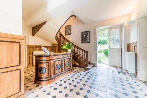 a hallway with a wooden console and stairs in a house at La Villa Ribière in Auxerre
