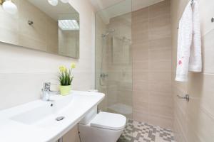 a bathroom with a toilet and a sink and a shower at FAMILY COTTAGE AMONG OLIVE TREES in Agüimes +28 photos