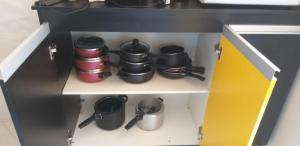 a toy kitchen with pots and pans on a shelf at Apartamento do Sr Luiz e dona cida in Lambari