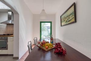 a dining room table with a bowl of fruit on it at FAMILY COTTAGE AMONG OLIVE TREES in Agüimes