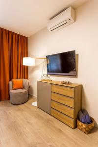 A television and/or entertainment centre at SCA Sofia City Apartments