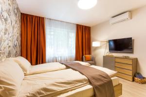 A bed or beds in a room at SCA Sofia City Apartments
