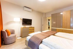 A bed or beds in a room at SCA Sofia City Apartments
