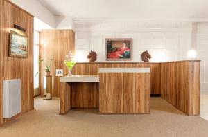 a lobby with a desk with a painting on the wall at Palihotel San Francisco in San Francisco