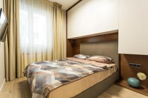 A bed or beds in a room at SCA Sofia City Apartments
