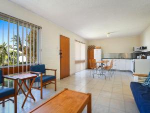 a living room with a couch and a table at Kendalls Beach Break in Kiama