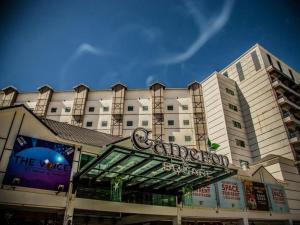 a large white building with a sign on it at Aranda Nova Suite in Cameron Highlands