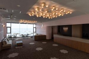 a hotel lobby with a view of the ocean at Oarai Hotel Annex Gyoraian in Oarai