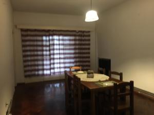 a dining room with a table and chairs and a window at Petit in Fray Bentos +6 photos