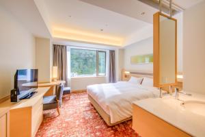Postelja oz. postelje v sobi nastanitve Atami Korakuen Hotel