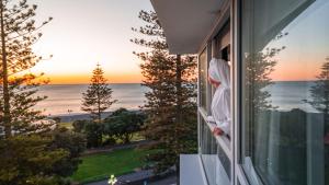 
a view from the balcony of a house overlooking the ocean at Scenic Hotel Te Pania in Napier
